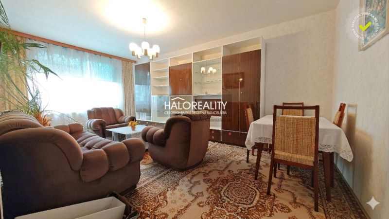 Living room with a comfortable sofa and a dining table in a 4-room apartment.