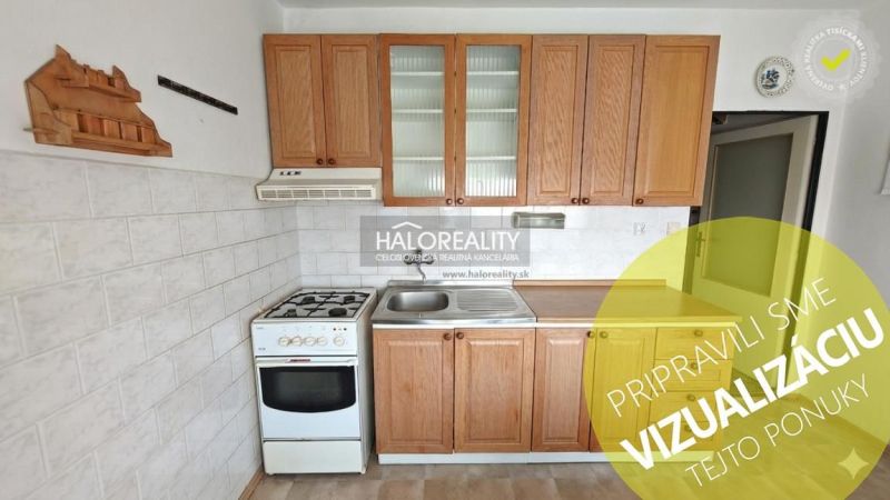 A kitchen in a 4-room apartment with wooden cabinets and a gas stove.