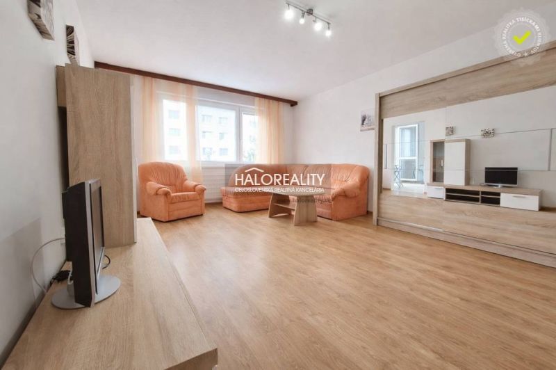 1-bedroom apartment with wood-patterned flooring, orange sofa set, bright interior.