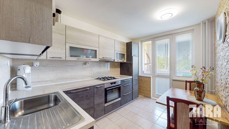 A kitchen in a 3-room apartment with a modern kitchen unit and a dining area.