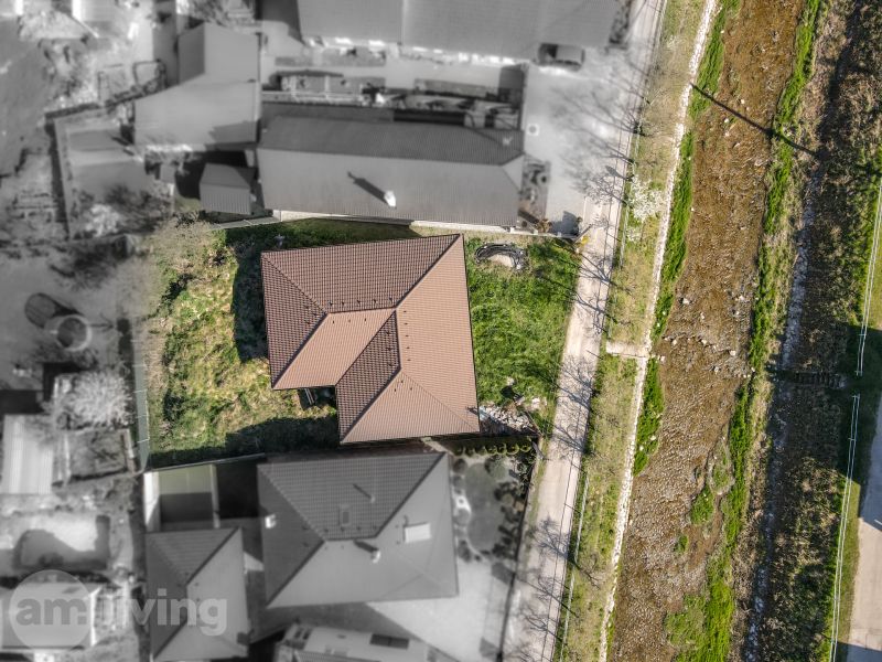 Aerial view of a family house in Drietoma surrounded by greenery and pathways.