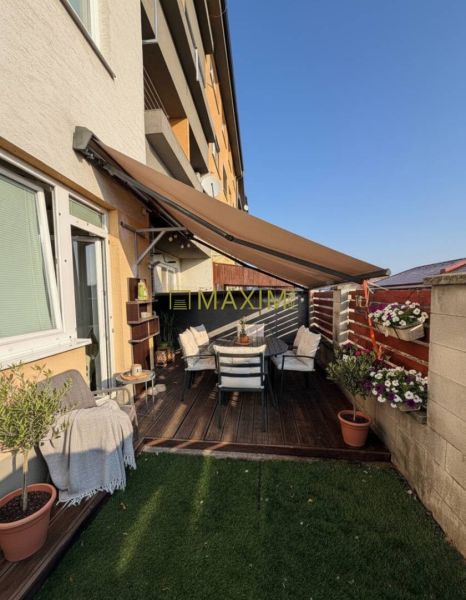 Terrace of a 2-room apartment with wooden decor and garden seating on M. R. Štefánik Street in Most pri Bratislave.