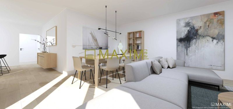 A spacious living room with a sofa and a wooden-patterned floor in a 2-room apartment.