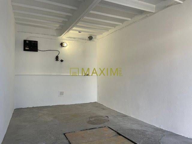 An empty interior with white walls and a concrete floor in a garage on Astronomická Street, Bratislava - Ružinov.