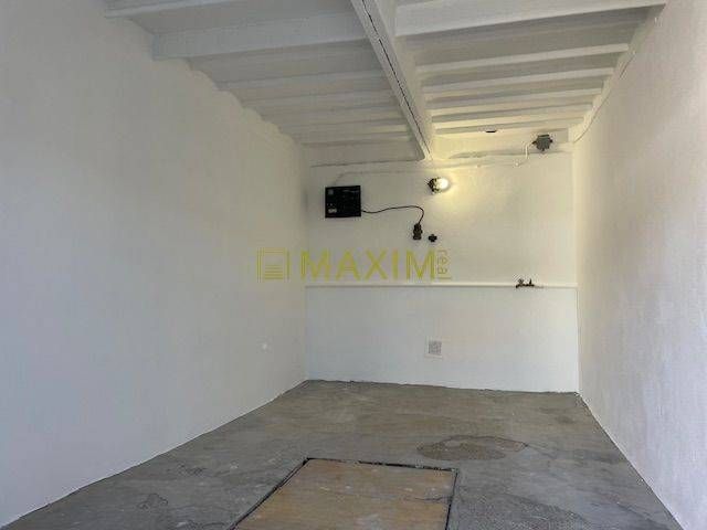 Garages on Astronomická Street in Bratislava - Ružinov with white walls and concrete floor.