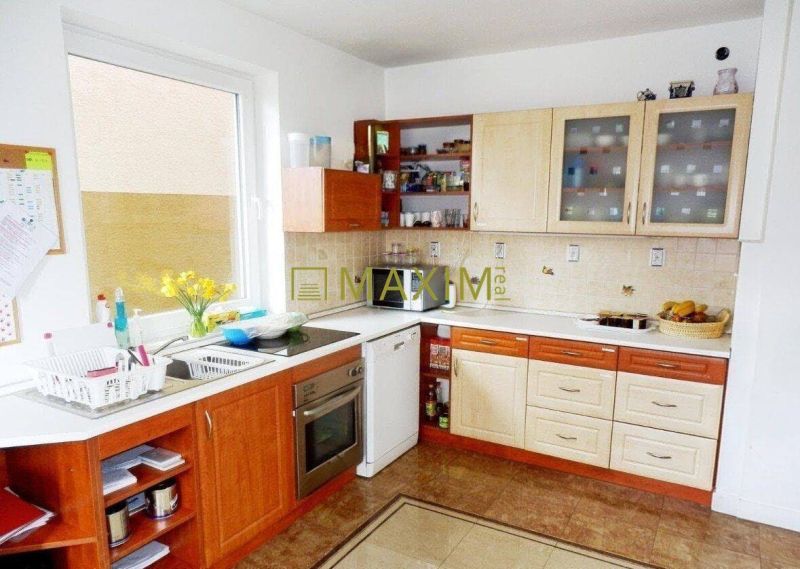 A kitchen in a cabin with wooden decor and white appliances.