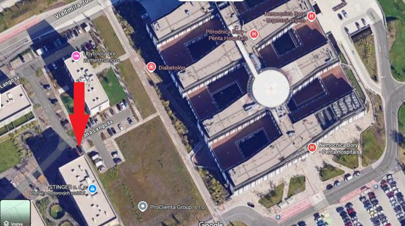 Aerial view of the Lamač area in Bratislava with a healthcare facility and parking lots.