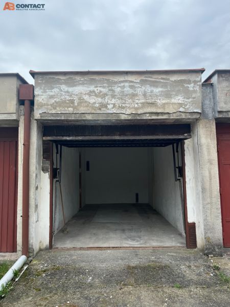 Open garage on Dopravná Street in Piešťany, with a concrete floor and an empty interior.