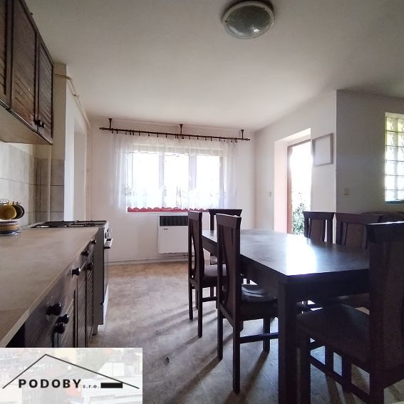 Dining room with a wooden table and chairs in a family house.