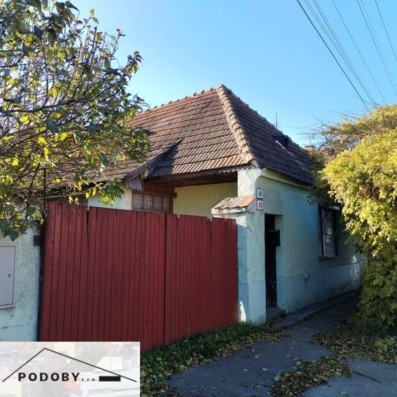 A family house in Veľké Úľany with a historical roof and a wooden fence.