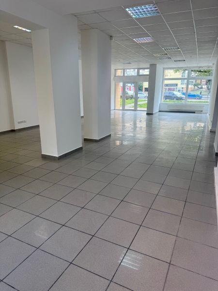Spacious commercial spaces with large windows and gray tiles.