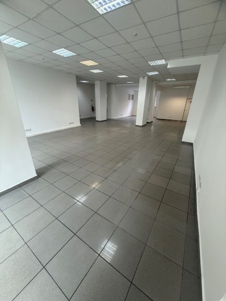 Spacious commercial spaces with tiles and white walls.
