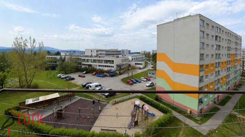View from a 3-room apartment on Rozkvet Street in Považská Bystrica, playground and parking lot.