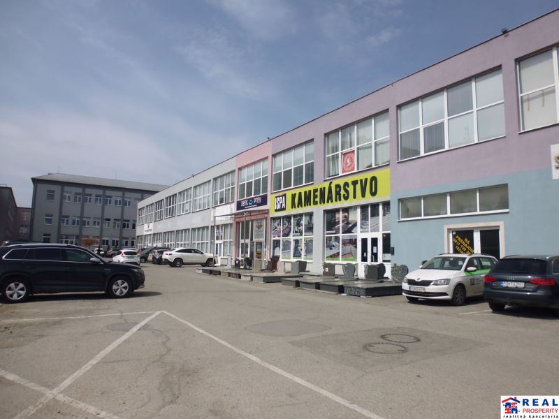 Commercial premises at Masarykova 22 in Prešov, showing a stone processing business with a parking lot.