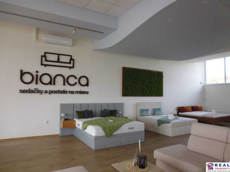 Commercial spaces with beds, sofas, and wooden decor on the floor, focusing on interior design.