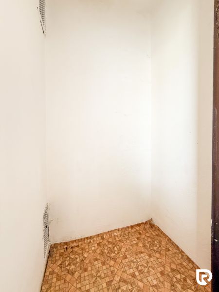 A white space in a 3-room apartment with geometric pattern ceramic tiles.