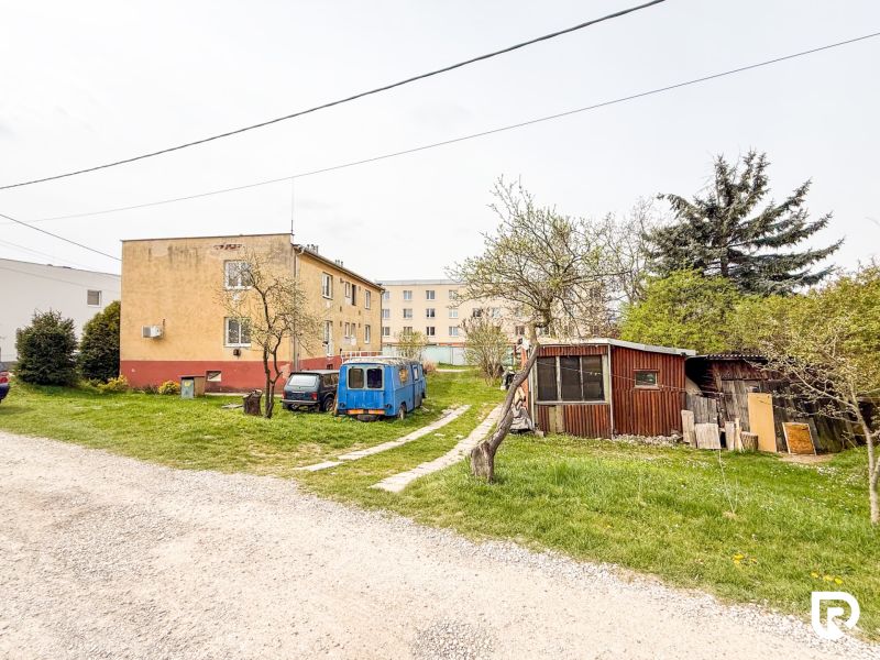A courtyard with buildings and cars on Hrabovská Street in Trenčín.