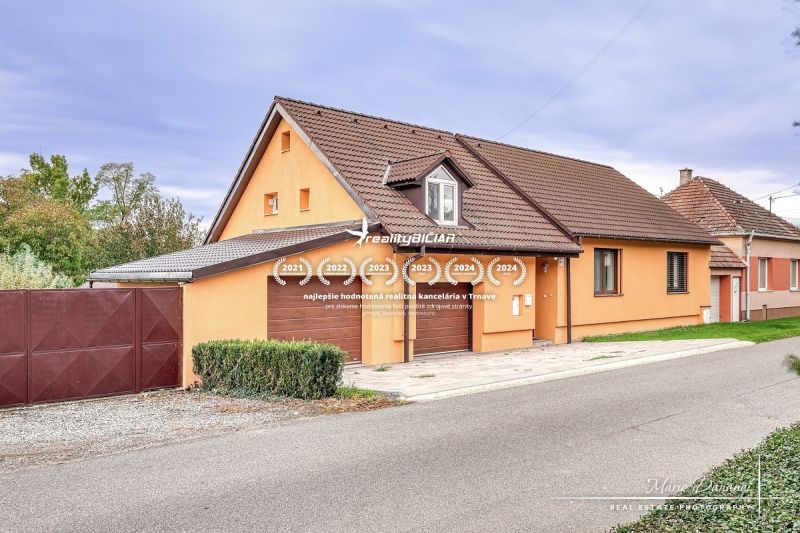 A family house in Špačince on Špačince Street with an orange facade and a brown roof.