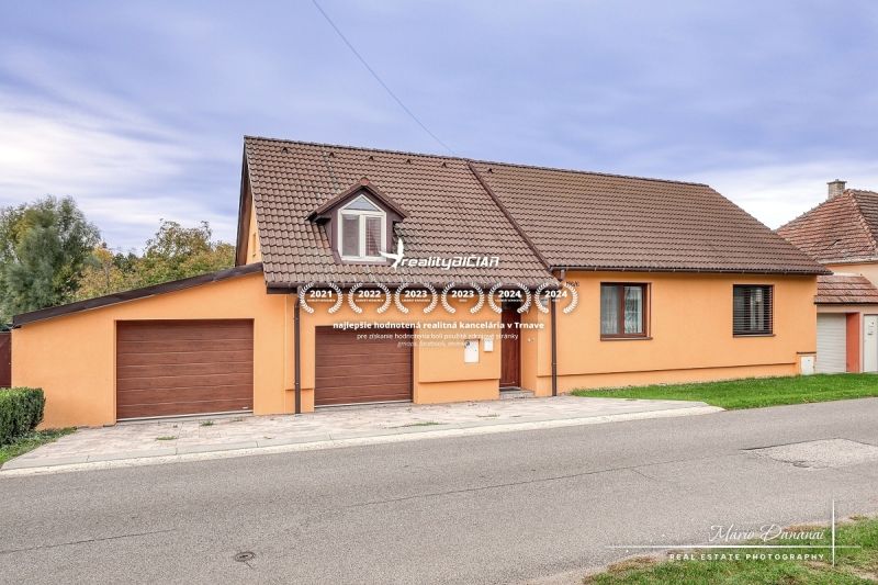 A family house on Špačince Street in Špačince with a pitched roof and a garage.