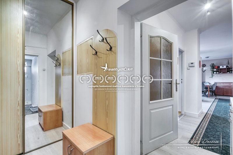 Hallway with a coat rack and mirror in a family house. Floor with wood decor.