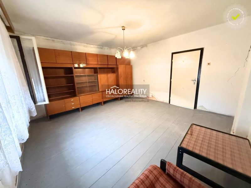 A spacious room with retro furniture and white walls in a family house.