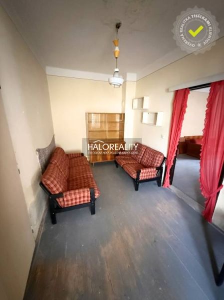 Living room in a family house with sofas and a curtain, capturing the interior.