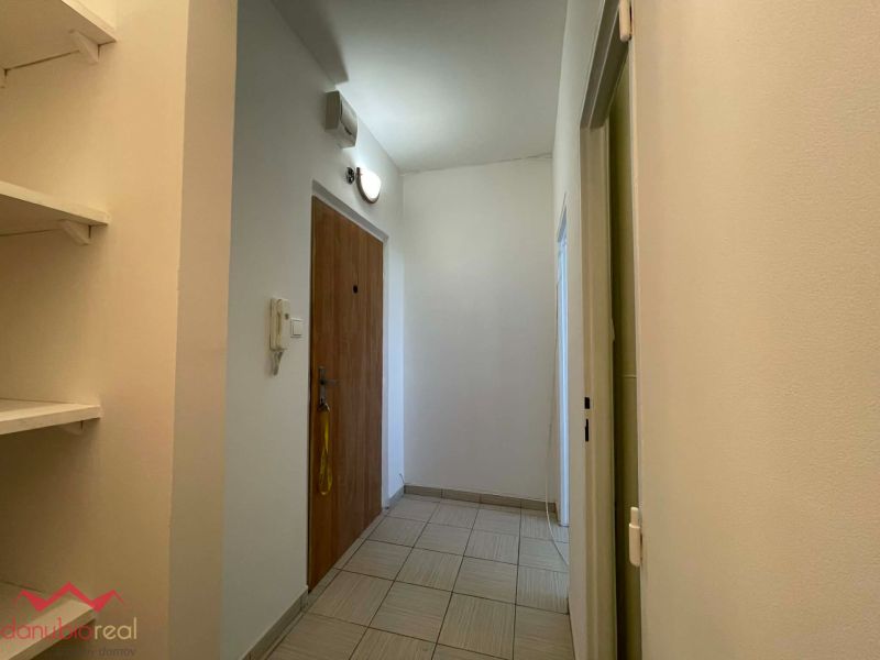 Entrance hallway in a 1-room apartment with tiles and doors on the right side.