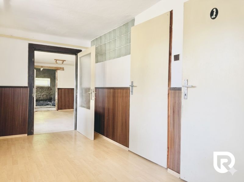 Room with wooden paneling and wood-patterned flooring, Real Estate - Housing.