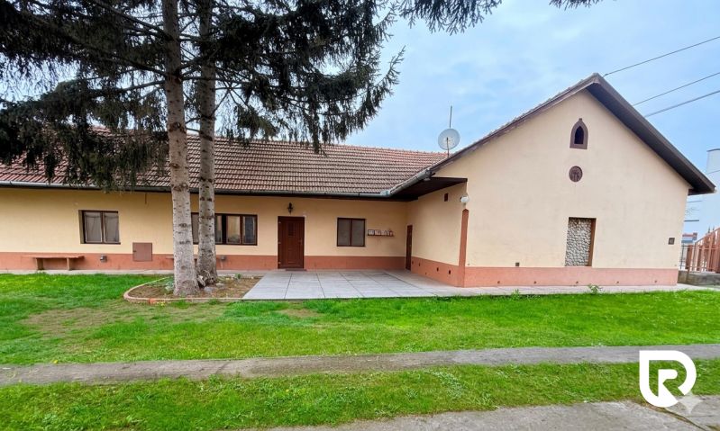 A single-story house with a red roof and a garden in Trenčín on Biskupická, suitable for living.
