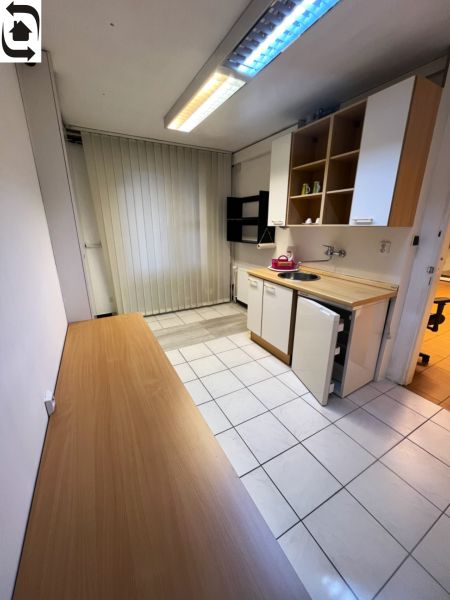 Offices with a kitchenette, tiles, and shelves, suitable for employees.