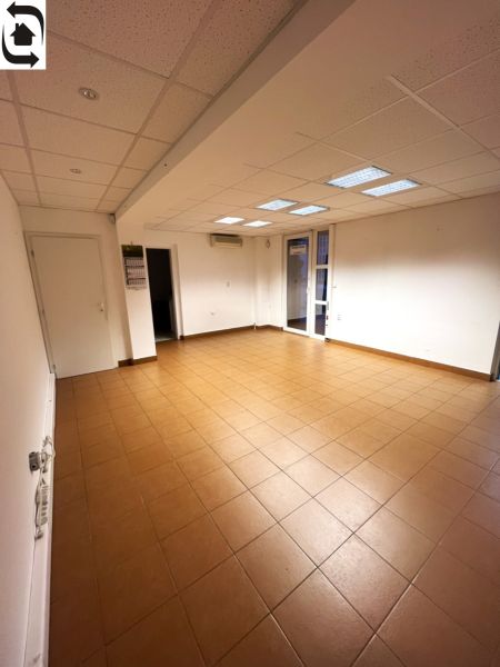 Offices with tiled floors, white walls, and a coffered ceiling.