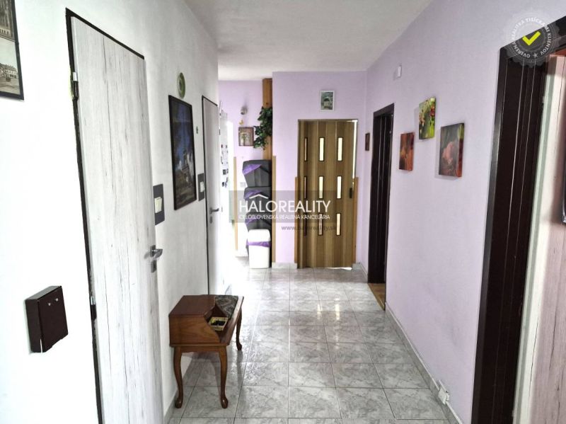 A hallway with entrances to rooms, decorative elements, and part of the furnishings in a 3-room apartment.
