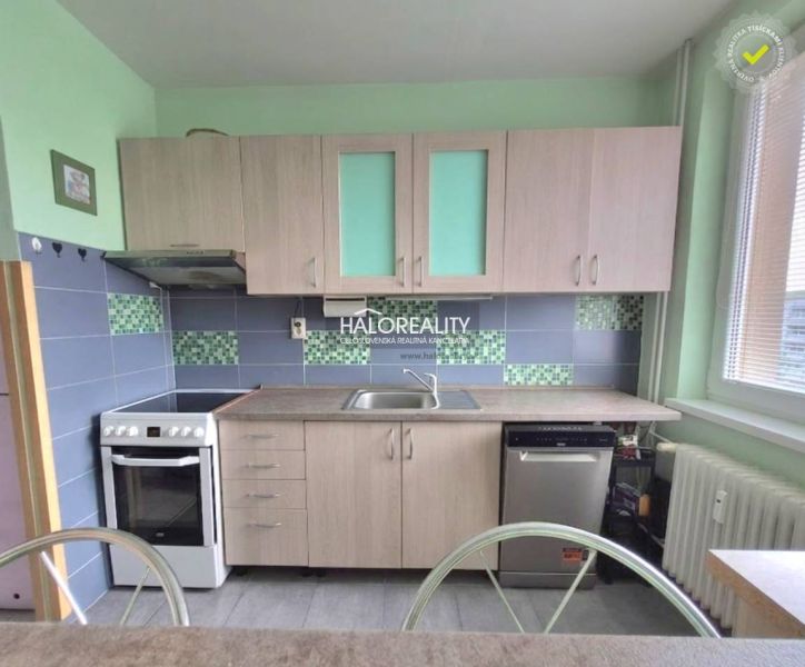 Kitchen in a 3-room apartment with a wooden decor, light cabinets, dishwasher, stove.