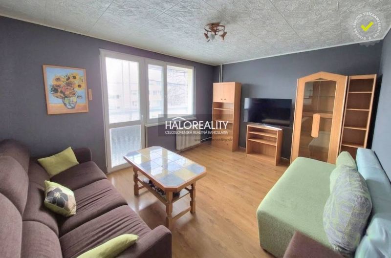 Living room with sofas, a coffee table, and a TV in a three-room apartment.
