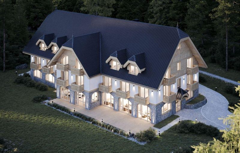 A hotel in the High Tatras with stylish architecture and wooden balconies in a natural setting.
