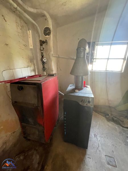 Boiler room in a family house with a boiler and chimney system.
