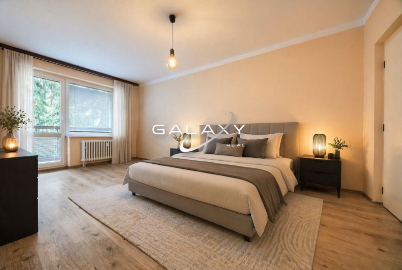 Bedroom with wood-patterned flooring in a 2-room apartment, elegant soft lighting.