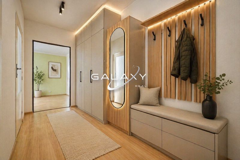 Entrance hall in a 2-room apartment with a wood-patterned floor and designer furniture.