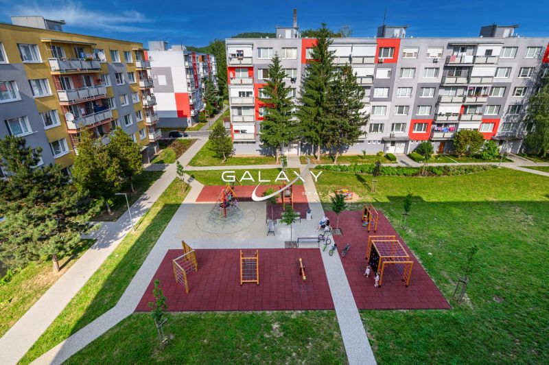 A playground surrounded by apartment buildings on Sládkovičova Street in Fiľakovo, an ideal environment for families.