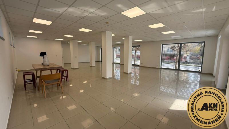 Spacious commercial spaces with shiny floors, columns, and windows for plenty of light.