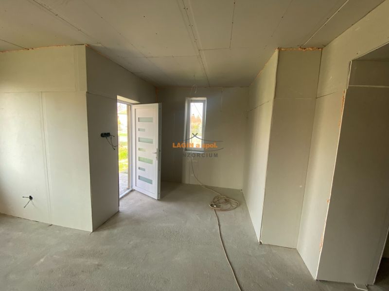 Interior of a family house with white doors and concrete floor.