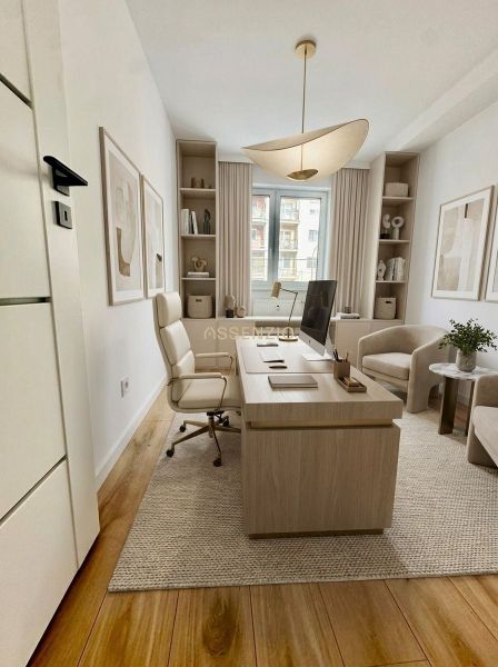 A study in a 4-room apartment with a wooden decor floor and comfortable furniture.