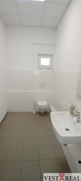 White toilets with a sink and a small window, Warehouses and halls.