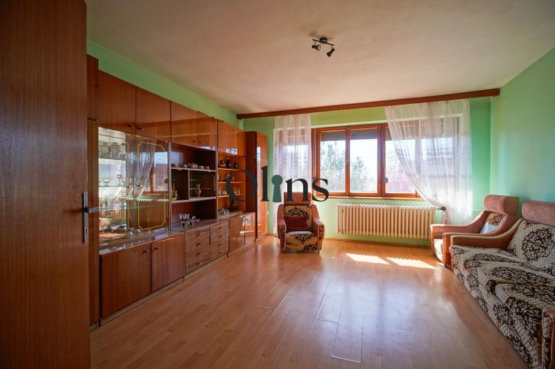 Living room in a family house with retro furniture and a wooden decor floor.