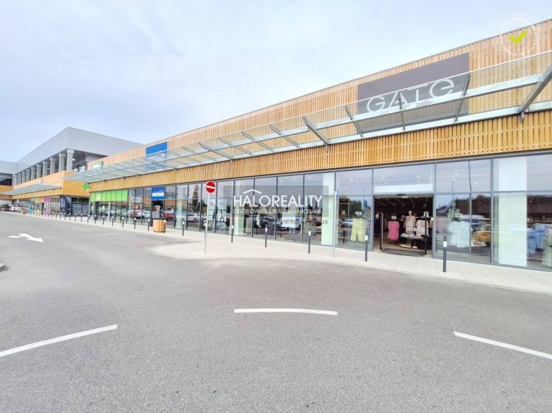 Shopping center with glass displays and a modern wooden facade in BA - Podunajské Biskupice.