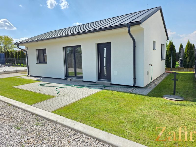 A family house in Kajal, with a lawn and terrace, ideal for living.