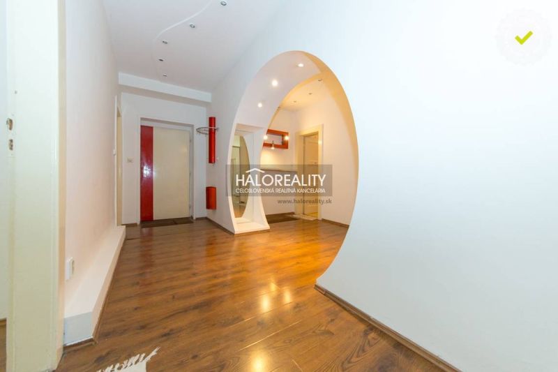 Wooden floor and white arched transition in a 5 or more room apartment.