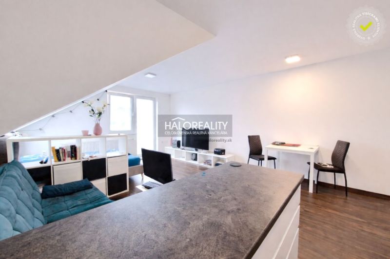 Living space in a 2-room apartment with a wooden decor floor and light decoration.