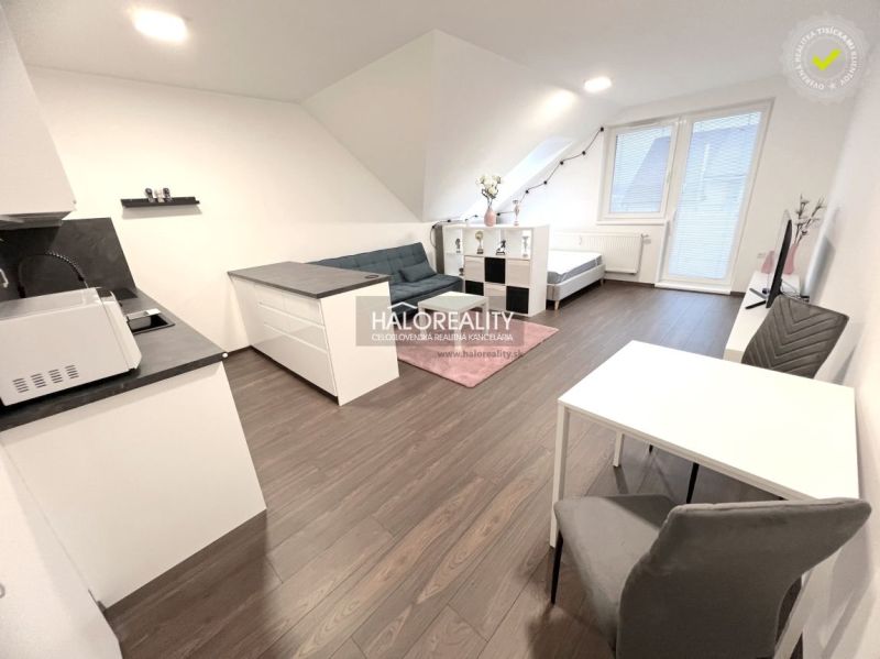 Interior of a 2-room apartment with a wooden decor floor and white furniture.