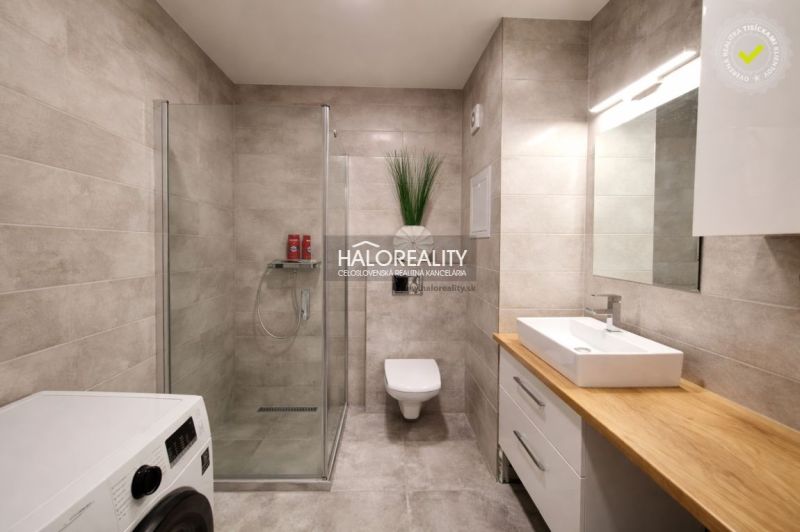 Bathroom with a shower in a 2-room apartment, floor with wood decor.